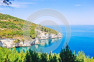 Beautiful cozy bay with boats and clear turquoise water in Italy