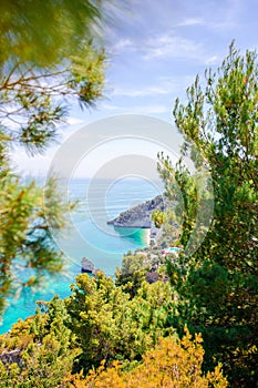 Beautiful cozy bay with boats and clear turquoise water in Italy