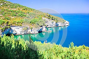 Beautiful cozy bay with boats and clear turquoise water in Italy