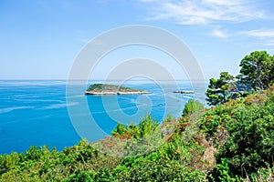 Beautiful cozy bay with boats and clear turquoise water in Italy