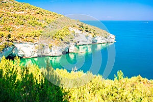 Beautiful cozy bay with boats and clear turquoise water in Italy