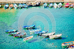 Beautiful cozy bay with boats and clear turquoise water in Italy coast, Manarola, Liguria, Europe