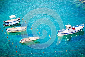 Beautiful cozy bay with boats and clear turquoise water in Italy, Europe