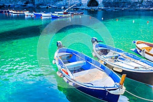 Beautiful cozy bay with boats and clear turquoise water in Italy, Europe