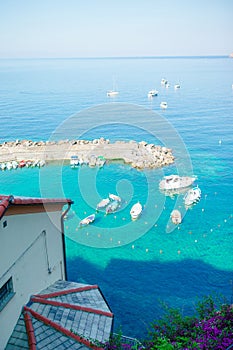 Beautiful cozy bay with boats and clear turquoise water in Italy, Europe