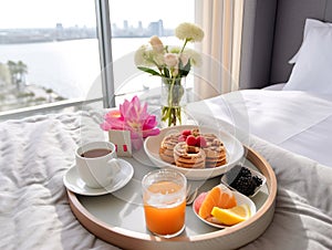 Beautiful cozy breakfast in bed, home bedroom interior with bright morning light, healthy food on decorated tray