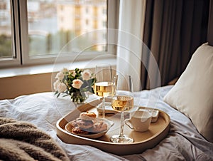 Beautiful cozy breakfast in bed, home bedroom interior with bright morning light, healthy food on decorated tray