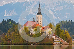 Beautiful cozy Lake Bled and the church on the island in the background with castle in the morning lights in the Julian Alps