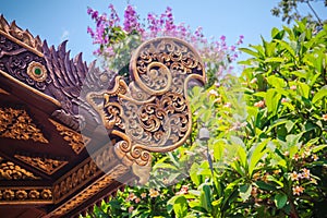 Beautiful craved naga pattern on the rafter and gable of the Tha