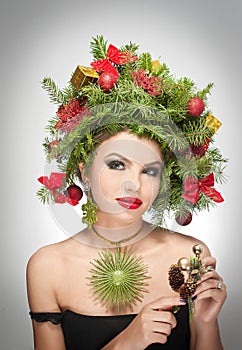 Beautiful creative Xmas makeup and hair style indoor shoot. Beauty Fashion Model Girl. Winter. Beautiful fashionable in studio