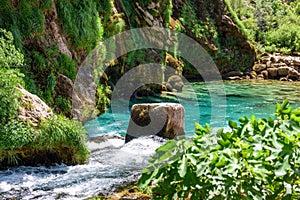 Beautiful creek and turquoise natural pool under rocky cliff at Krcic waterfall near Knin, Croatia