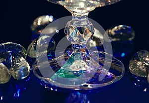 Beautiful crystal glass stem, blue background, color reflections, luxury background, retro