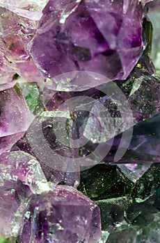 Beautiful crystal magic amethyst gem stone. Texture of specimen with scattered natural light effect.