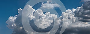 Beautiful cumulus clouds against the blue sky.. Panoramic shot of a cloud cluster. Wide format