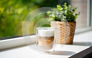 Beautiful cup of cappuccino under warm sunlight to warm up your moring.