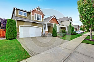 Beautiful curb appeal of American house with olive exterior paint.