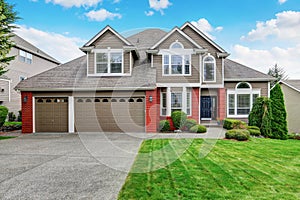 Beautiful curb appeal of beige house with red brick trim