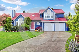 Beautiful curb appeal with blue exterior paint and red roof.