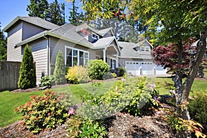 Beautiful curb appeal of classic American home with nice landscape design.