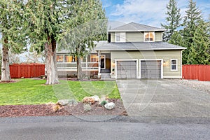 Beautiful curb appeal of a green siding home