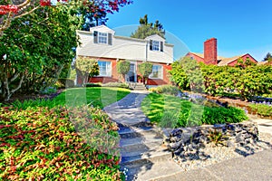 Beautiful Curb appeal of two level house with nice front garden and concrete walkway. .