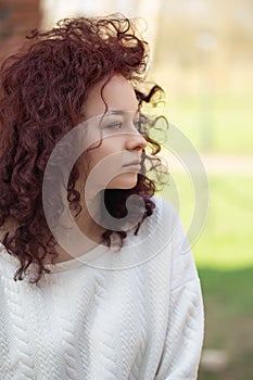 beautiful curly slav woman in a white sweater