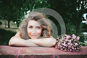 Beautiful curly woman with flowers