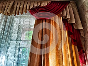 Beautiful curtain on the window and transparent tulle curtain. Abstract background, texture, pattern. Space for text and