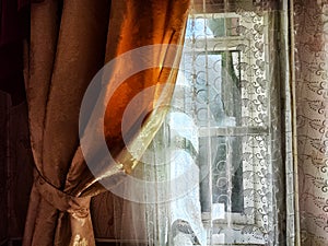 Beautiful curtain on the window and transparent tulle curtain. Abstract background, texture, pattern. Space for text and