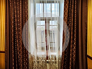 Beautiful curtain on the window and transparent tulle curtain. Abstract background, texture, pattern. Space for text and