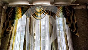 Beautiful curtain on the window and transparent tulle curtain. Abstract background, texture, pattern. Space for text and