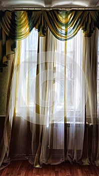 Beautiful curtain on the window and transparent tulle curtain. Abstract background, texture, pattern. Space for text and