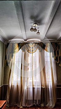 Beautiful curtain on the window and transparent tulle curtain. Abstract background, texture, pattern. Space for text and