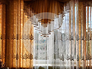 Beautiful curtains on the window with tulle, thick curtains and the sky in the background. Abstract texture, frame