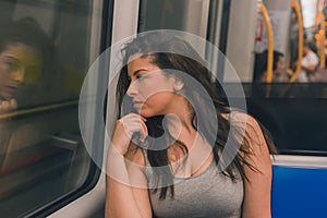 Beautiful curvy girl posing in a metro car