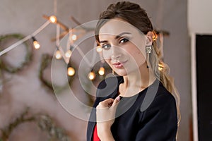 Beautiful cute attractive girl in festive evening jewelry jewelry