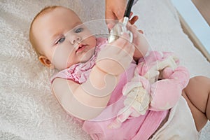 Beautiful cute baby girl with doctor with stethoscope