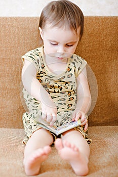 Beautiful cute baby reading a book