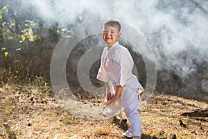 Beautiful cute baby standing in a pose of readiness to fight in nature