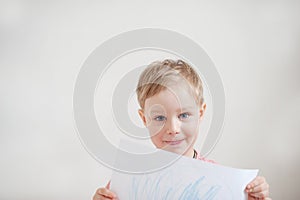 Beautiful cute boy with a drawing