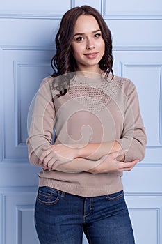 Beautiful cute girl with a smile demonstrates knitted clothes