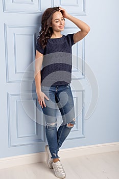 Beautiful cute girl with a smile demonstrates knitted clothes