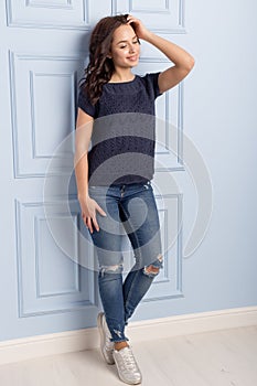 Beautiful cute girl with a smile demonstrates knitted clothes photo