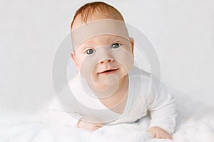 Beautiful cute laughing baby. Boy or girl on white. Little child