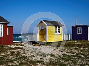 Beautiful cute little wooden beach huts summer houses, painted in lively colors, Aero Island, South Funen, Denmark