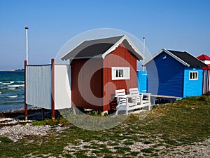 Beautiful cute little wooden beach huts summer houses, painted in lively colors, Aero Island, South Funen, Denmark