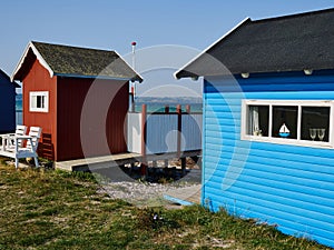Beautiful cute little wooden beach huts summer houses, painted in lively colors, Aero Island, South Funen, Denmark