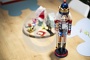 Beautiful and cute modern wooden soldier as a Christmas decoration on a wooden table