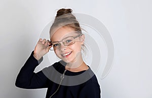 Beautiful cute smiling little girl with glasses