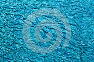 A beautiful cyan color handmade paper of crumple or wrinkle texture with veins and fibers.